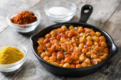 fried-spicy-chickpeas-frying-pan-wooden-table_11zon