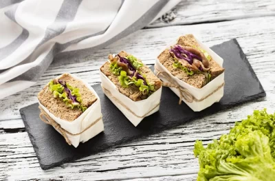 high-angle-sandwiches-slate-with-salad_23-2148640208