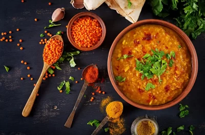 traditional-indian-soup-lentils-indian-dhal-spicy-curry-bowl-spices-herbs-rustic-black-wooden-table_11zon